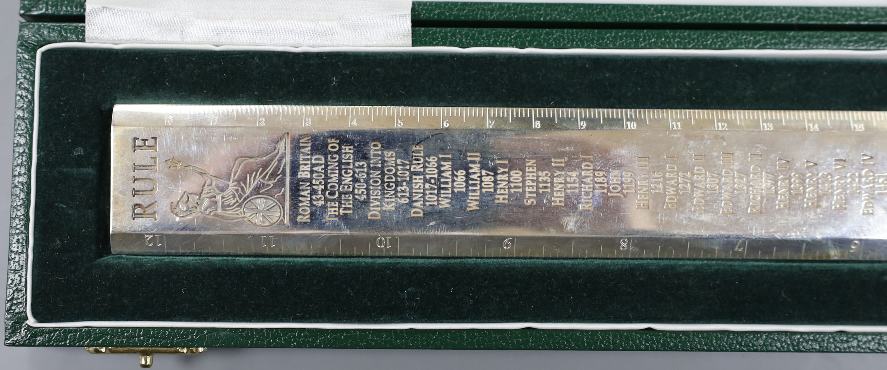 A cased modern Britannia standard silver 'Rule' ruler, engraved with the names and dates of the English Monarchy, by Richard O. A. Jarvis, London, 1977, 9.5oz.